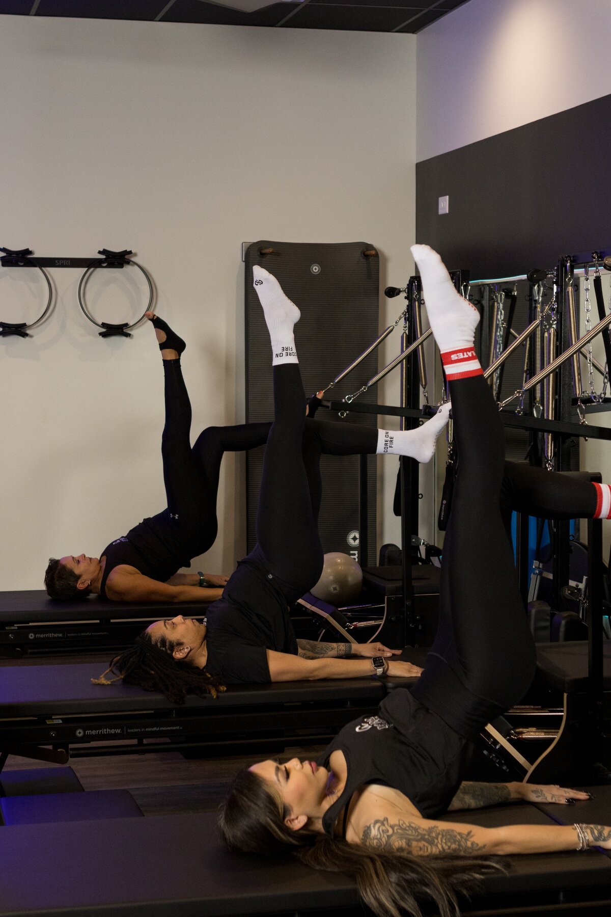 Pilates tower class at Core Ambitions with wall-mounted equipment