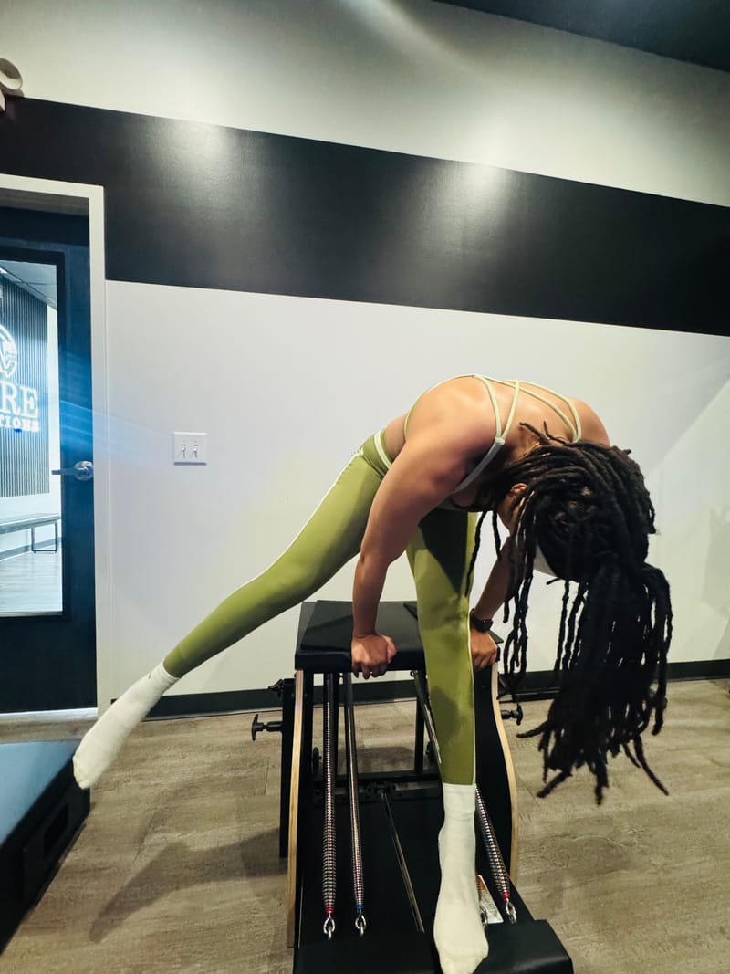Side leg stretch on the Stability Chair during a private session at Core Ambitions