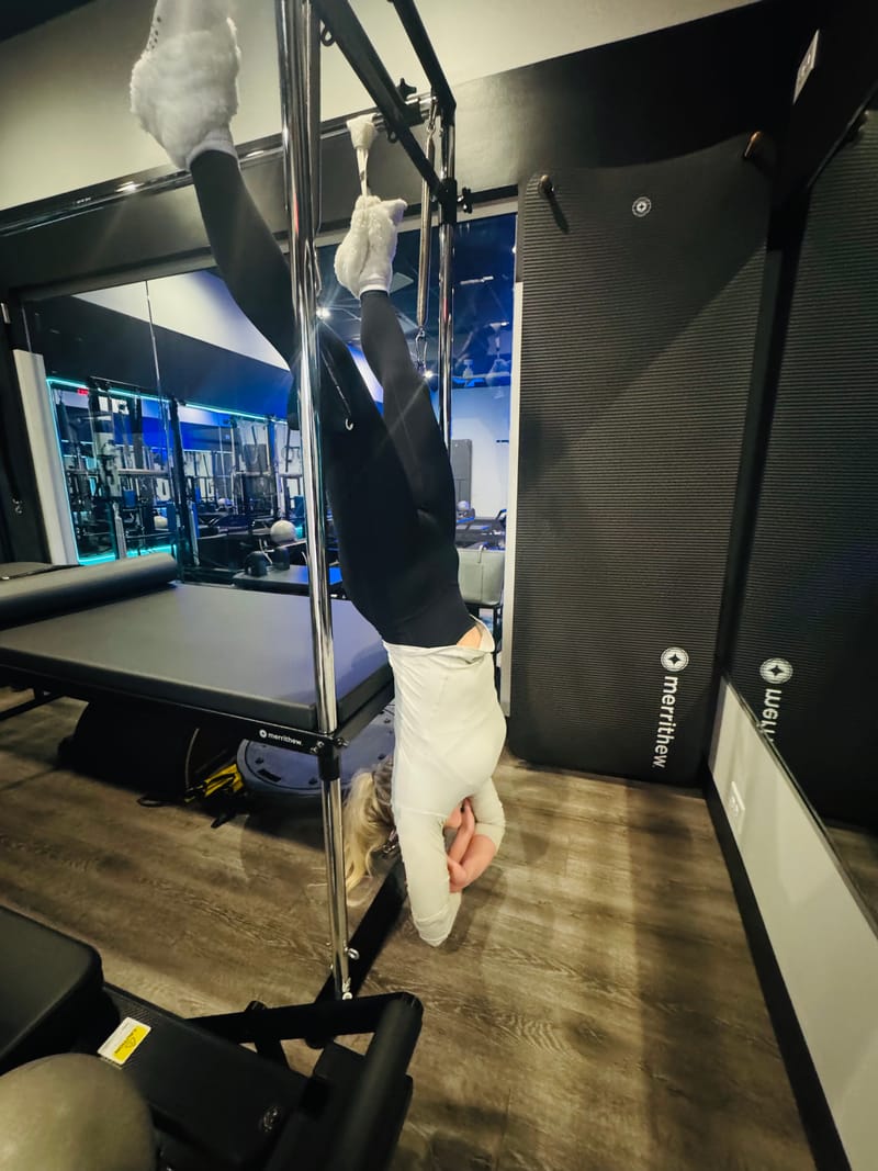 Full hang on the Cadillac Trapeze Table during private training at Core Ambitions