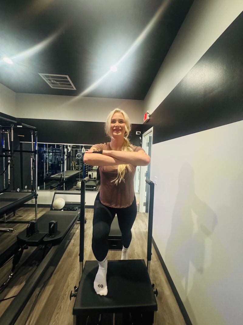 Standing Reformer box exercise during private Pilates session at Core Ambitions